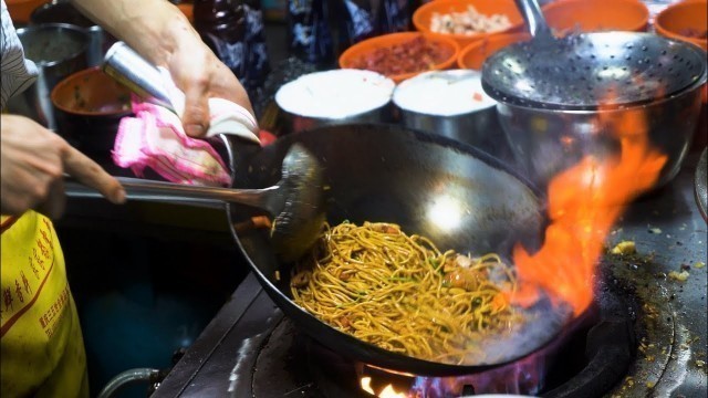 'Chinese Street Food -Fried noodles with egg and fried rice at night market, skewers at food stalls'