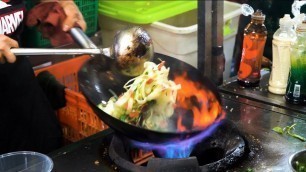 'Chinese Street Food -Fried rice noodles with egg, crispy pork belly, pan fried pork bun'