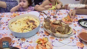 'Egyptians enjoy traditional food \"Fattah\" at Eid festival'